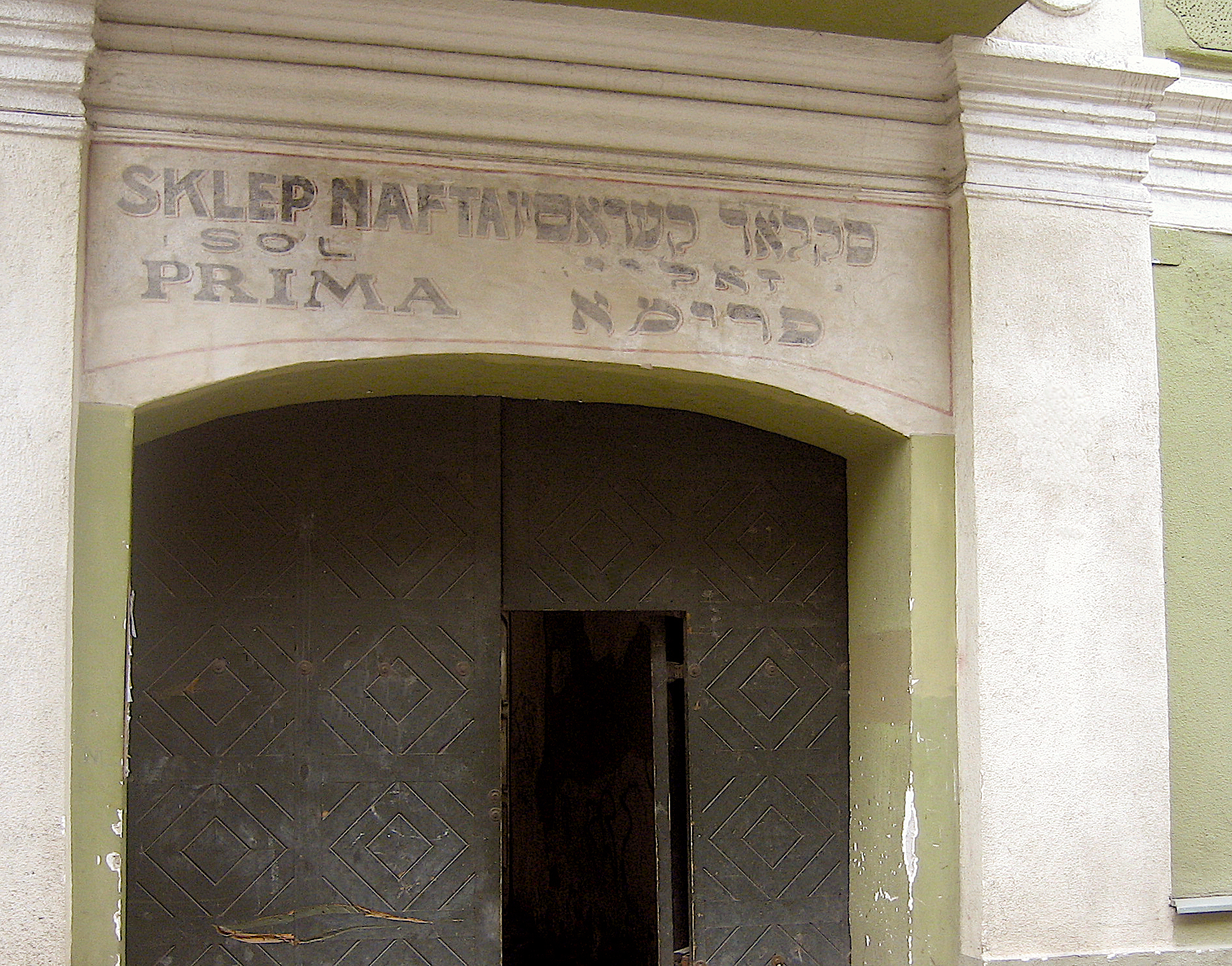 A doorway in the old Jewish Quarter of Vilnius, Lithuania, with text in both Yiddish and Polish above the door